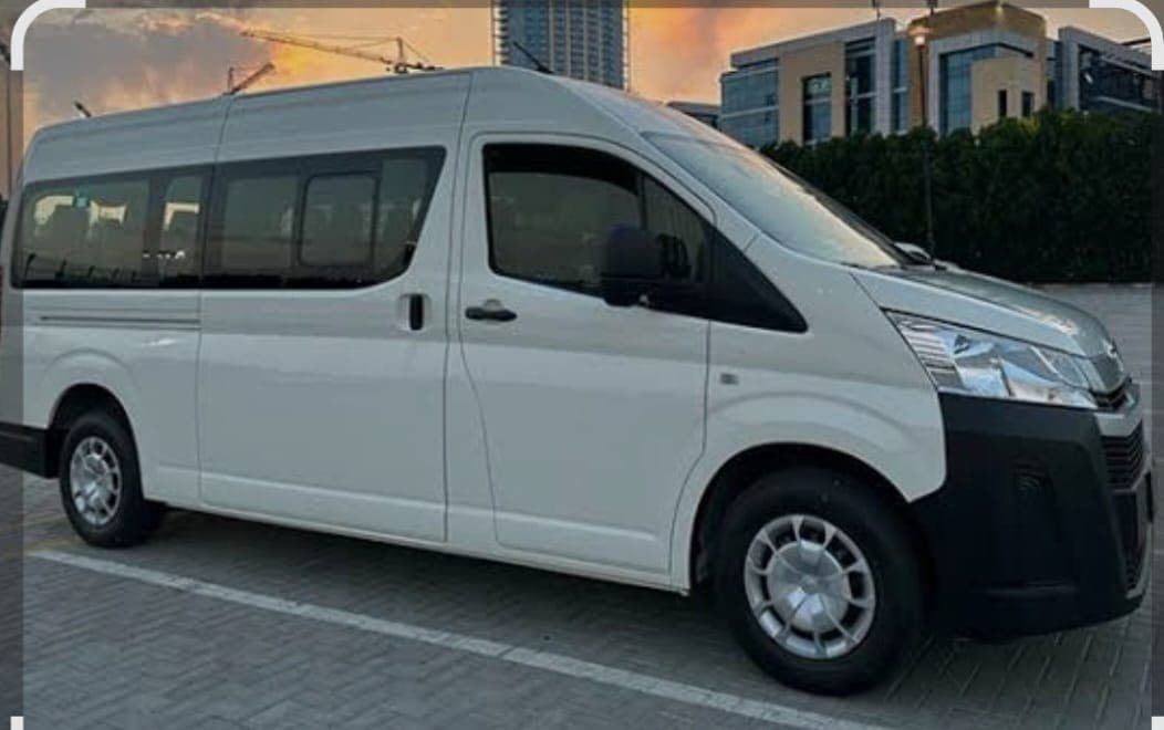 A high roof passenger van from the Al Asr Al Jadeed Transport fleet parked in Dubai
